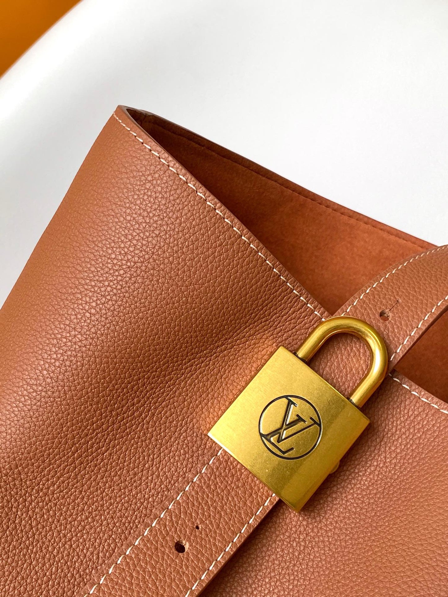 Louis Vuitton Classic Brown Leather Tote Bag with Gold Lock Accent and Shoulder Straps